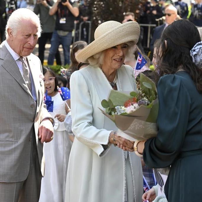 Children greet King Charles III and Queen Camilla outside a Sydney church